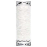 A spool of Gutermann bobbin thread for embroidery in white. Code 1001.