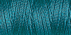 Spool of peacock blue coloured rayon embroidery thread. Code 1090.