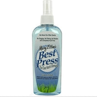 A spray bottle of Mary Ellen’s Best Press in Linen Fresh scent contains blue liquid in a for quilting, with product details on the front label.