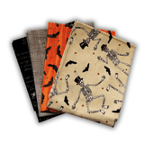Four Halloween-themed quilting fabric fat quarter bundle with skeletons, bats, and pumpkins, placed on a white background.