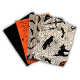 Four Halloween-themed quilting fabric fat quarters with different designs. placed on a white background