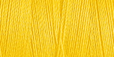 Close up of a spool of bright yellow thread