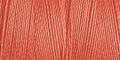 Close-up of a coral-colored yarn swatch