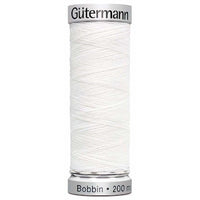 A spool of Gutermann bobbin thread for embroidery in white. Code 1001.