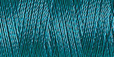 Spool of peacock blue coloured rayon embroidery thread. Code 1090.