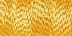 Spool of rayon embroidery thread in a mustard yellow. Code 1167.