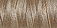 Spool of mushroom beige coloured rayon embroidery thread. Code 1180.