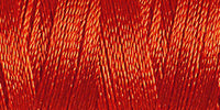 Spool of smokey red coloured rayon embroidery thread. Code 1181.