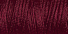 Spool of burgundy coloured rayon embroidery thread. Code 1189.
