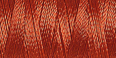 Spool of dusky rose coloured rayon embroidery thread. Code 1216.