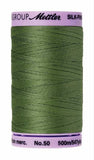 A 500m spool of Mettler silk coated cotton thread in soft green (code 0840), ideal for piecing.