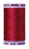 A 500m spool of Mettler silk coated cotton thread in red (code 0504), ideal for piecing.