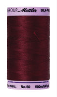 A 500m spool of Mettler silk coated cotton thread in cranberry (code 0918), ideal for piecing.