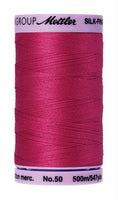 A 500m spool of Mettler silk coated cotton thread in fuscia (code 1421), ideal for piecing.
