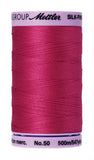 A 500m spool of Mettler silk coated cotton thread in fuscia (code 1421), ideal for piecing.