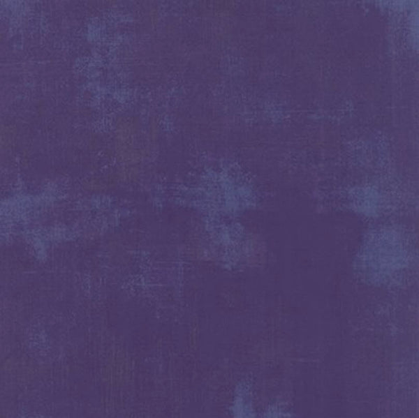 A square of purple quilting fabric with a light purple distressed look as part of the design