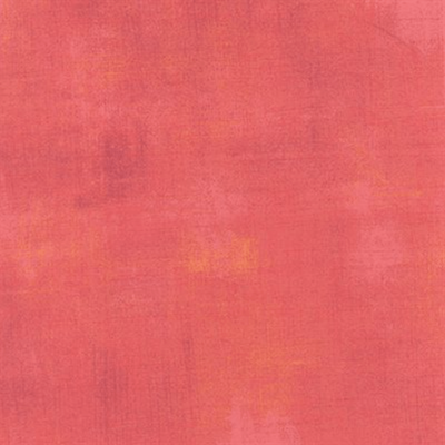 Deep salmon coloured fabric with a grunge distressed look