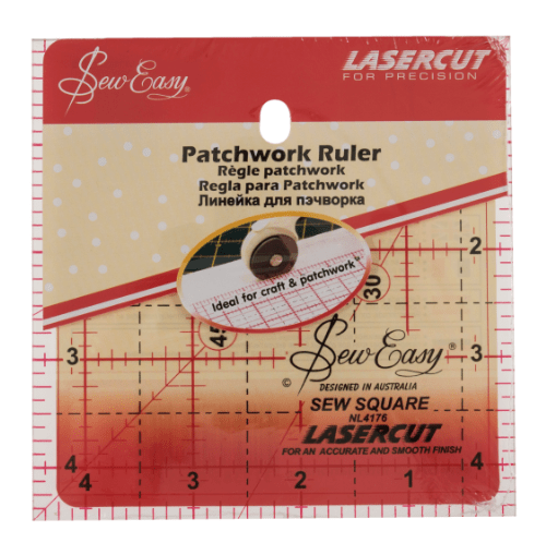 A 4.5" square patchwork ruler with red markings and a red removable label.