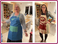 Two women wearing aprons in a kitchen setting.