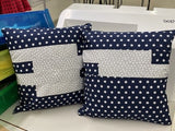 Two fabric bags with star and dot patterns on a white surface.
