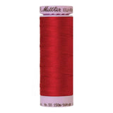 A 150m spool of Mettler silk coated cotton thread in red (code 0504), ideal for piecing.