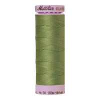A 150m spool of Mettler silk coated cotton thread in soft green (code 0840), ideal for piecing.