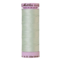 Spool of pale green cotton thread in Luster code 0018