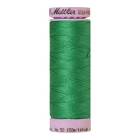 A spool of swiss ivy green cotton thread - code 0247