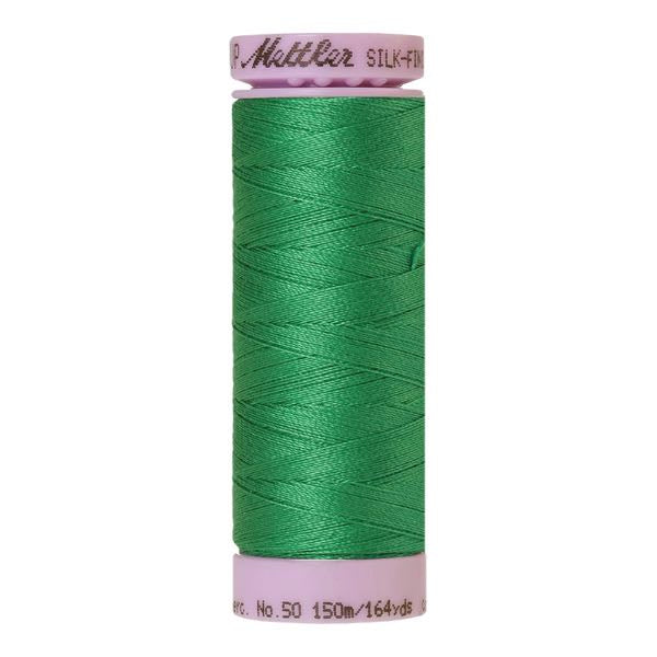 A spool of swiss ivy green cotton thread - code 0247
