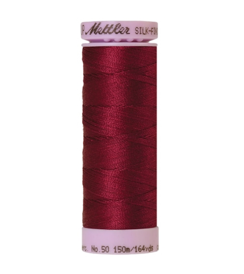 Spool of Mettler Silk Finished Cotton Thread in colour Pomegranate 0869
