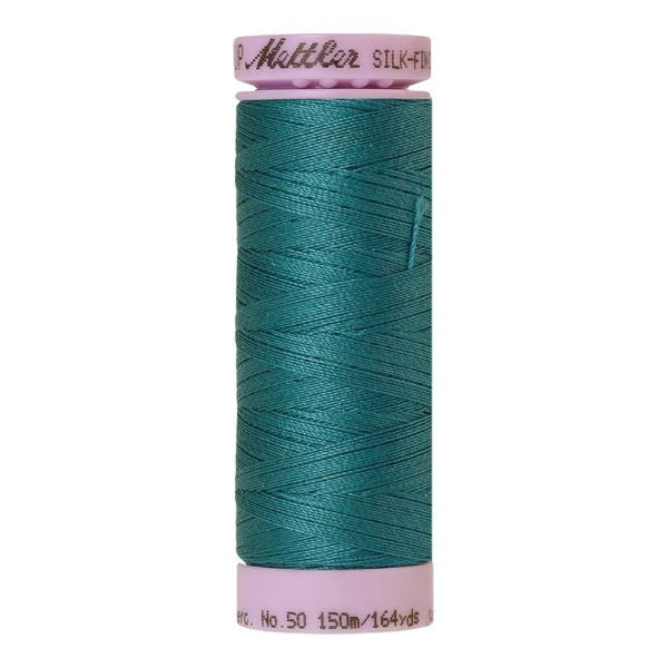 Spool of blue-green coloured cotton thread - Caribbean code 1471