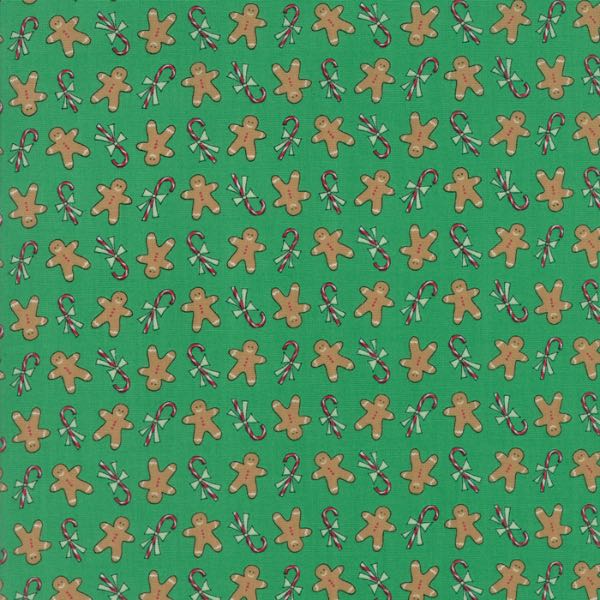 Green quilting fabric with gingerbread men and sugar cane design
